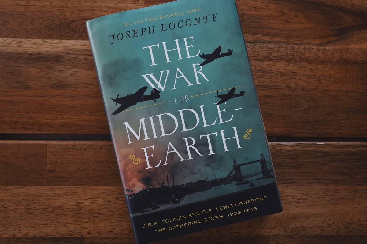 Reader analyzing books on zombie apocalypse for survival tactics