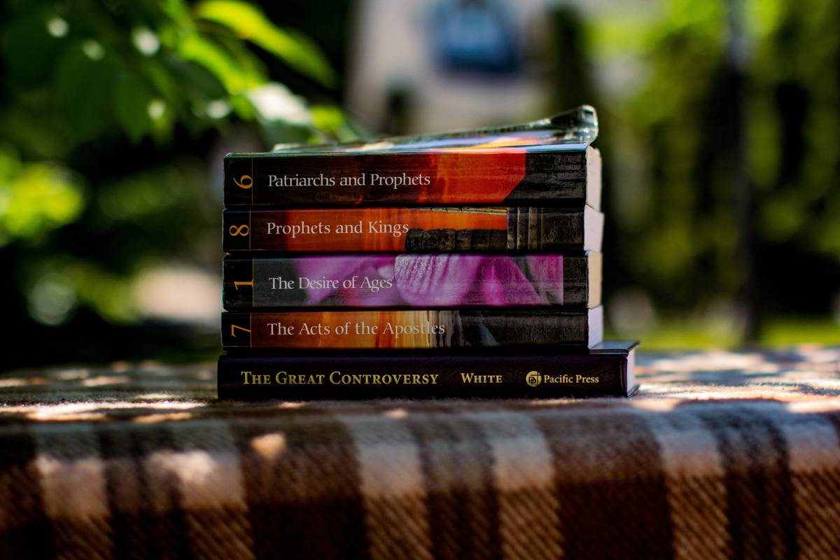 Stack of zombie apocalypse books for young adults featuring gritty cover art and survival themes